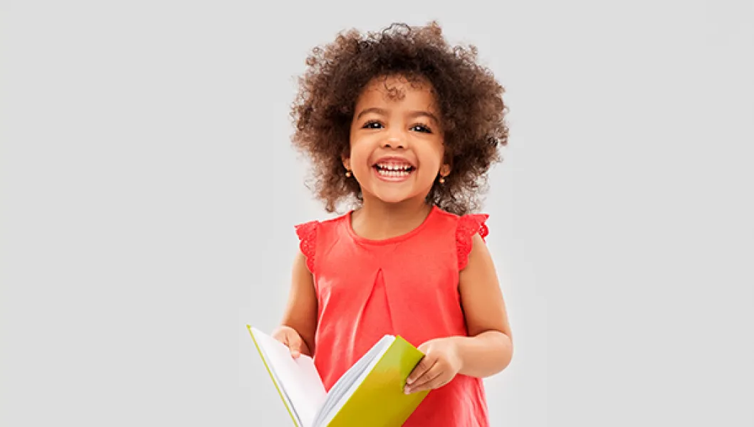 Girl with book smiling