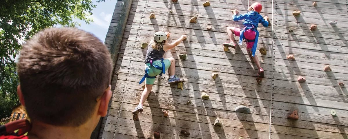 Kids supervised on climbing wall