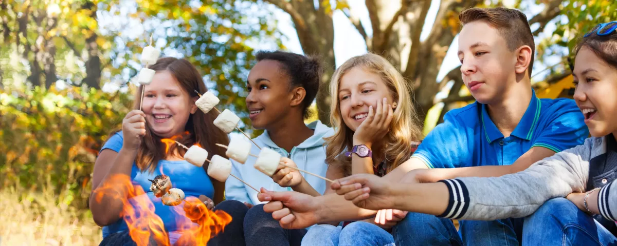 Teens roasting marshmallows