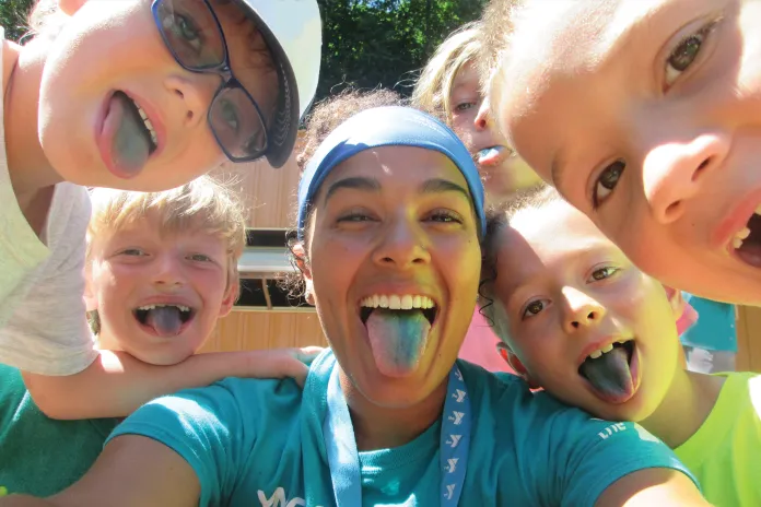 Camp participants and counselor making silly faces