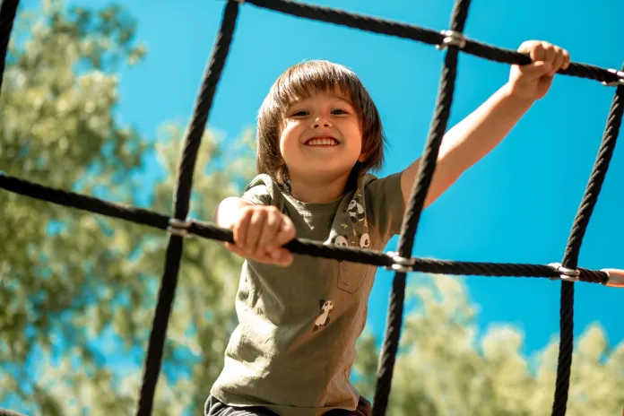 Child playing on a climbing net