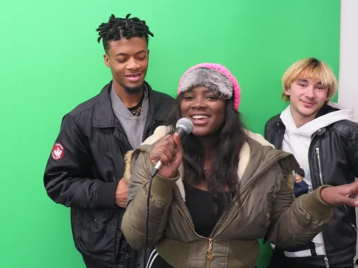 Three teens, a green screen, and a microphone