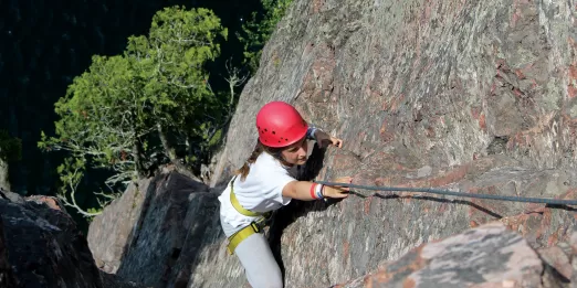 Teenage girl rock climbing