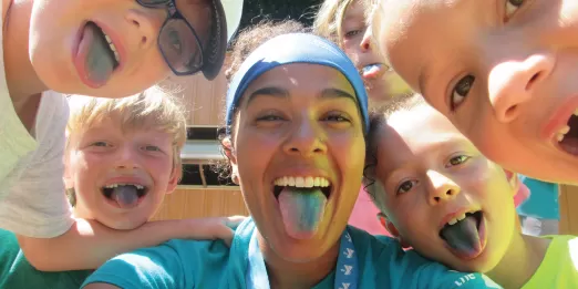 Camp participants and counselor making silly faces